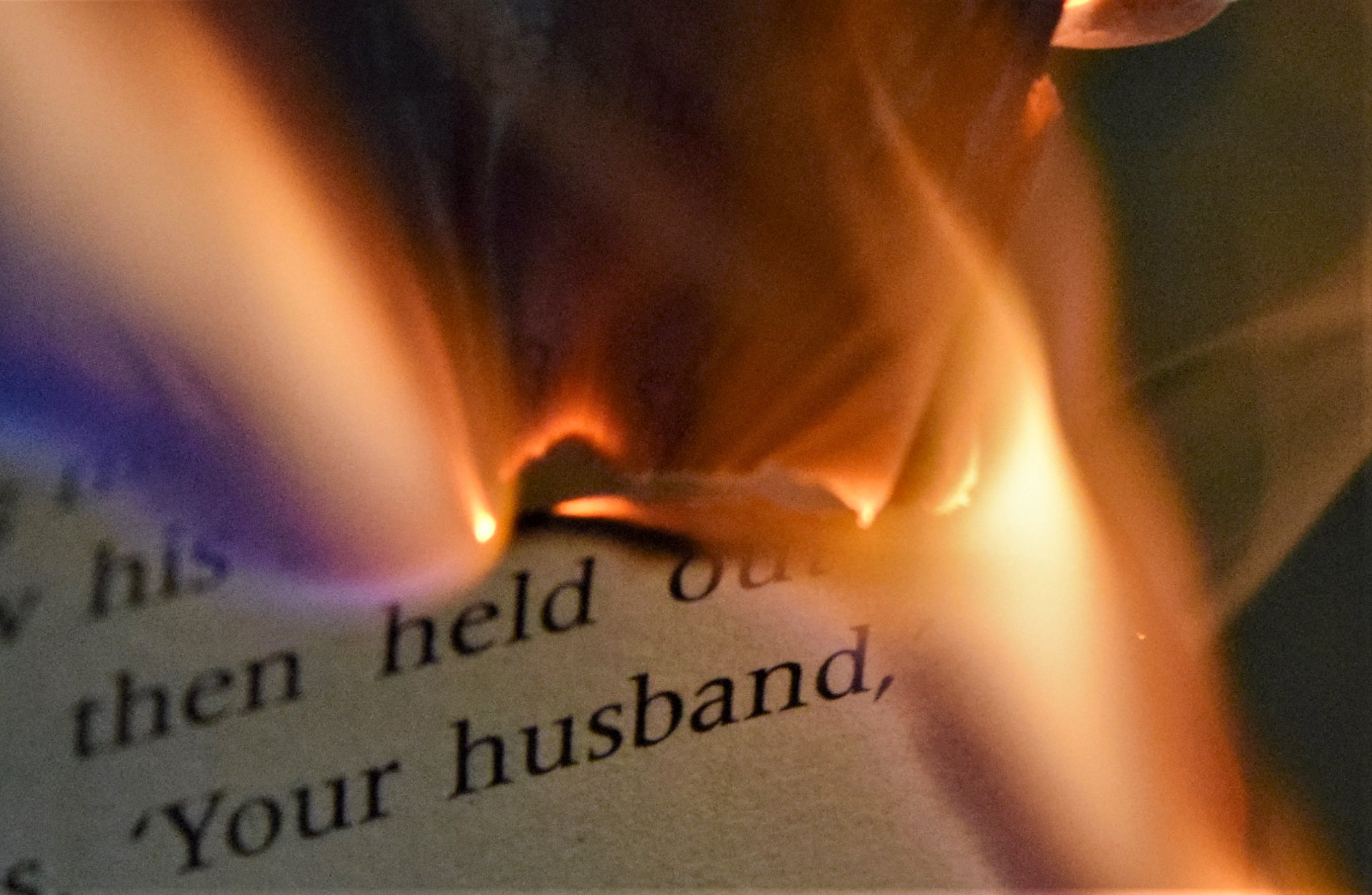 Pages of a book burning in a small fire