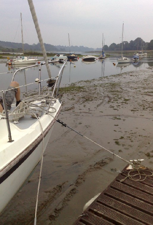 Tiki back on her mooring. Just ahead of the bow you can see grooves in the mud where she went aground.