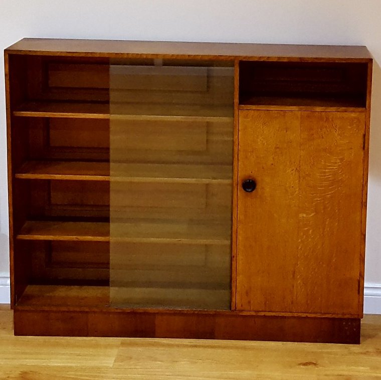 A glass fronted wooden cabinet, empty in this picture