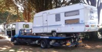 Caravan on a flatbed truck