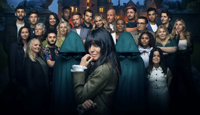 Claudia Winkleman is turning to look at the camera while standing in front of the contestants