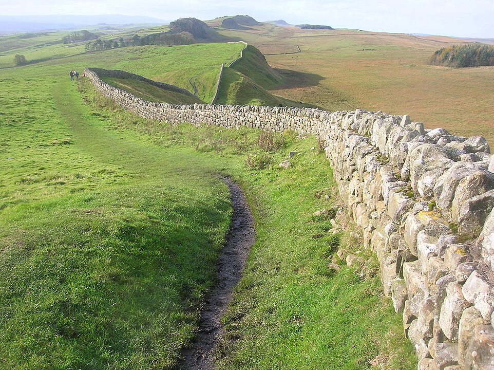 A stone wall snakes across a broad landscape