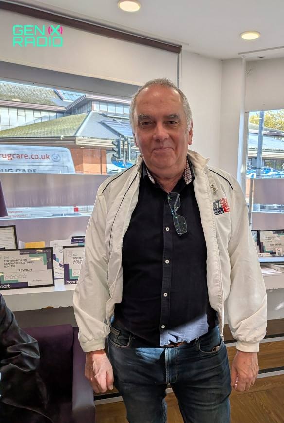 Phil Archer wearing his 40 year old DJ jacket smiling self-consciously