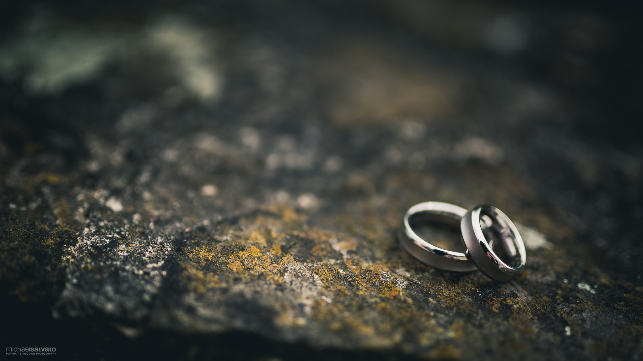 Two wedding rings placed on a rock